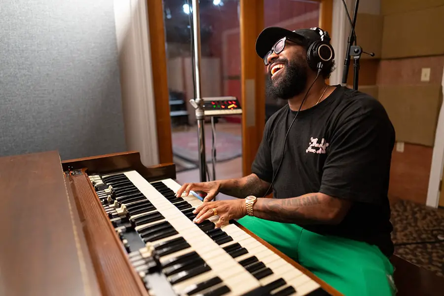 Musician PJ Morton at the piano recording the Tiana’s Bayou Adventure soundtrack