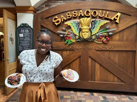 Danielle at Disney's Port Orleans Resort holding plates of beignets