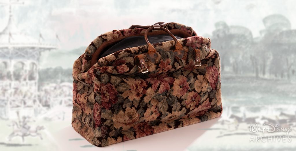 Mary Poppins’ carpet bag is shown. It’s a floral-pattern carpet bag, with leather handles and straps.