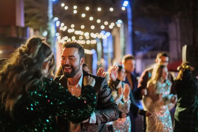 Guests dance at Holiday Fiesta en la Calle