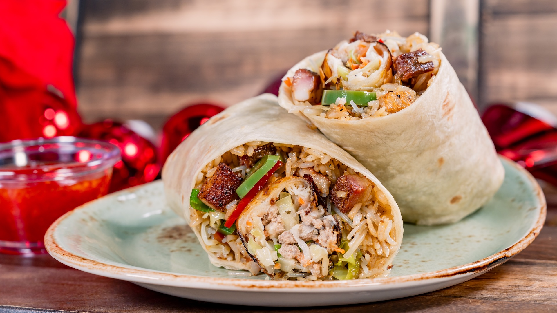 Filipino Feast Burrito: Pork belly adobo fried rice, pancit, and lumpia in a warm flour tortilla with sweet chile dipping sauce