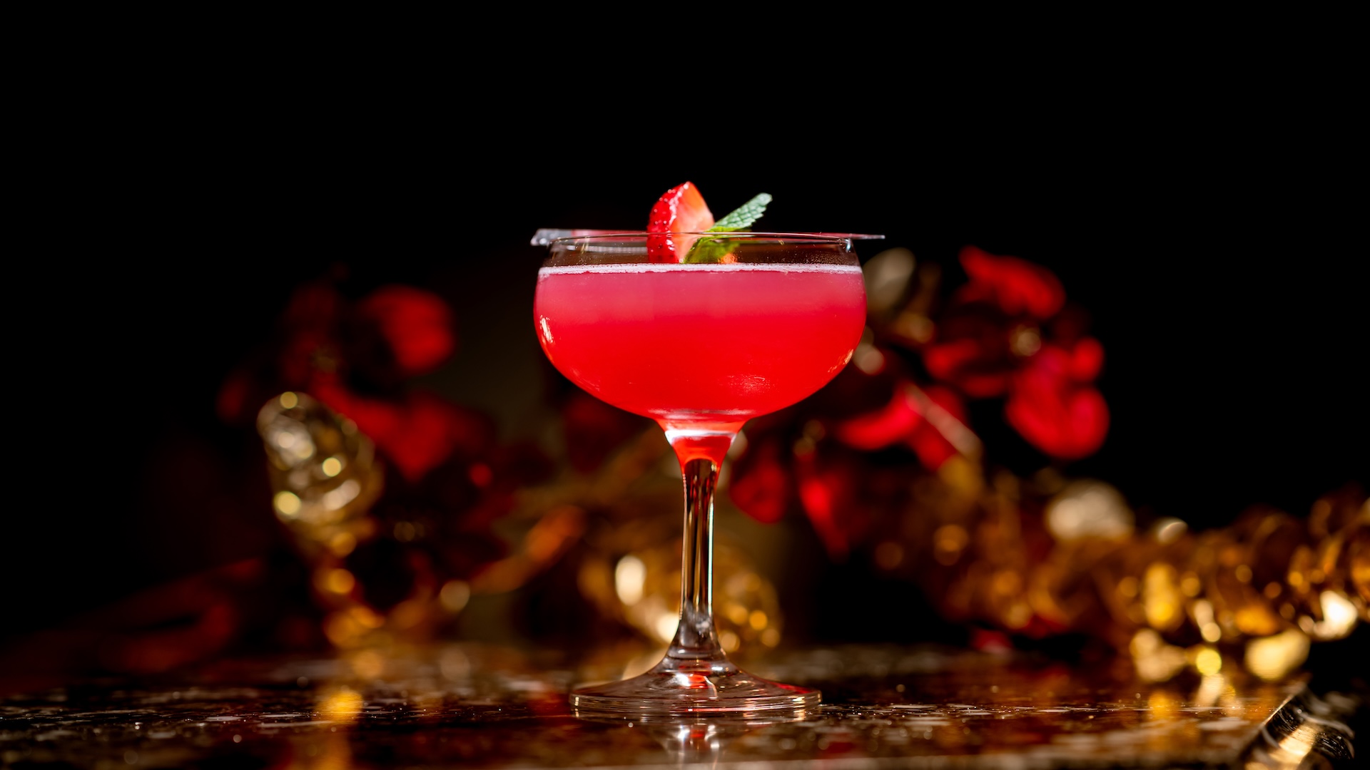 Golden Moonfire Cocktail: Pomegranate martini served with a strawberry-mint garnish (New)  