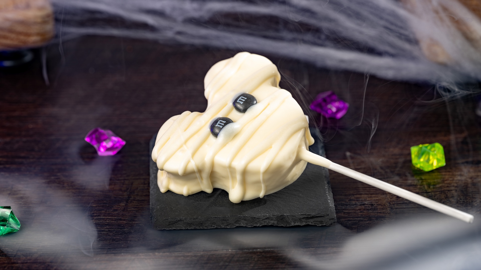 Mickey Mummy Marshmallow Pop with M&M’S Milk Chocolate Candies: Marshmallow with white chocolatey coating and M&M