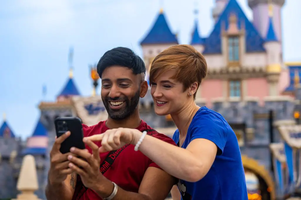 Guest scanning mobile pass at Disneyland park entrance turnstile