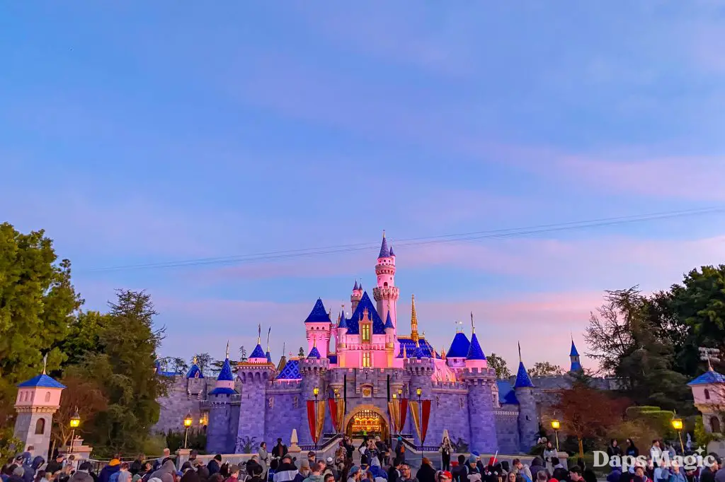 Early morning rope drop crowd facing Sleeping Beauty Castle at Disneyland