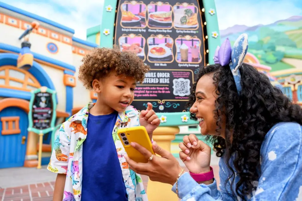 Guest using Disneyland App on smartphone to select attraction return times
