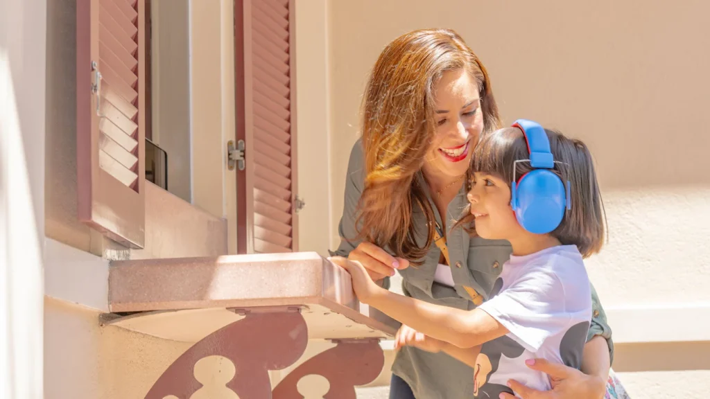 Disneyland Cast Member assisting guests at Accessibility Kiosk